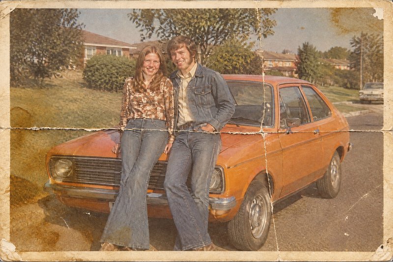 Before: a 1970s couple-and-car print with deep folds, water stains and faded color