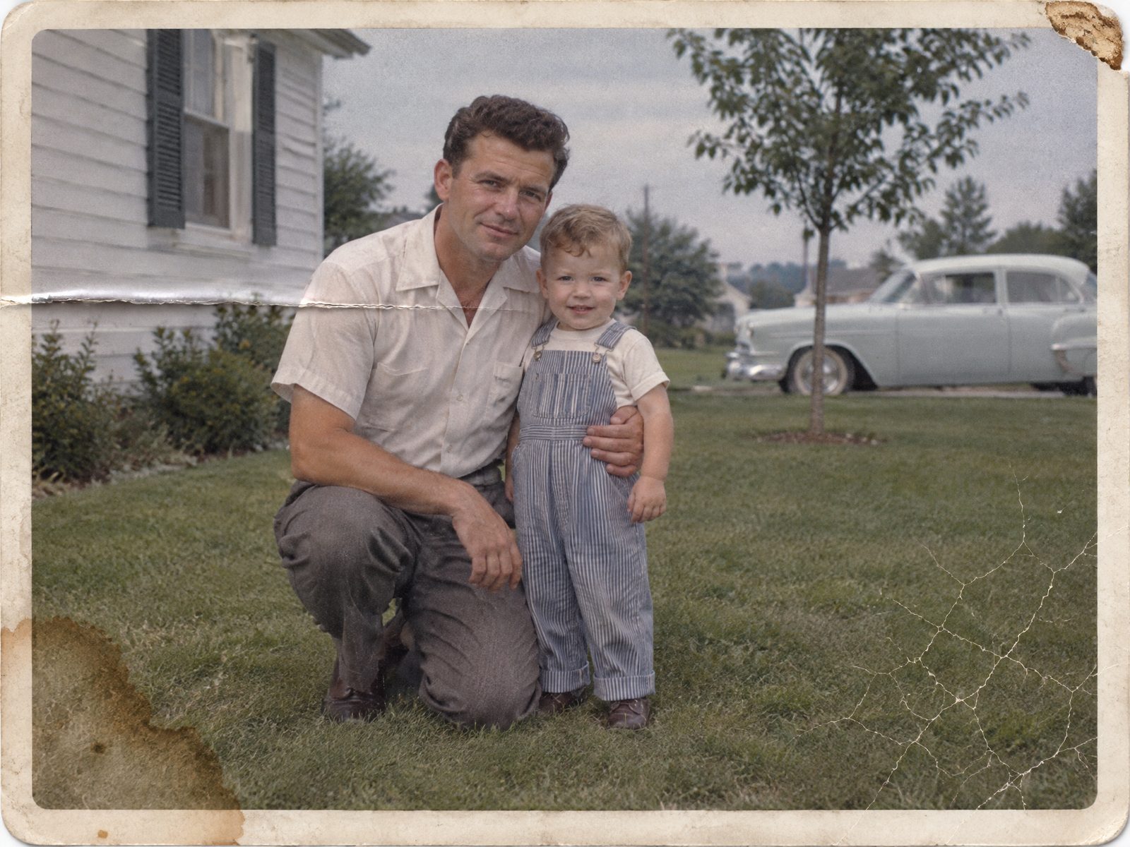 Before: 1950s father and son print with a wallet fold, a brown stain and a chipped corner