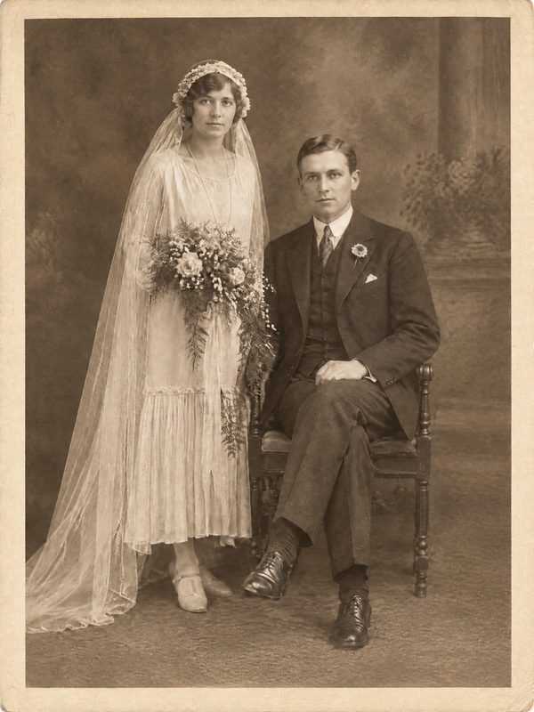 After: the fold and stain repaired, still sepia, same couple and pose